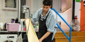 Artist holding a fabric in the studio