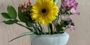 A ceramic planter holding a bouquet of flowers