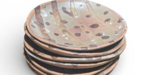 A stack of ceramic plates against a white background
