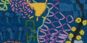 Coloured embroidary on a blue cloth