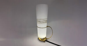 White pillar lamp with bronze accents.