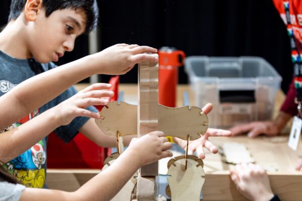 A girl with her mom at a pretend fishing pond