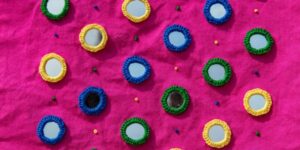 A bright pink fabric with embroidery details