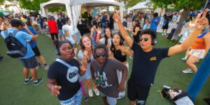 A group of kids doing Silent Disco wearing headphones outdoors