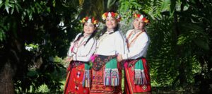 A group of three women in red attire posing for the camera