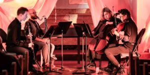 A group of musicians playing in an indoor concert.