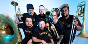 A group of musicians posing with their instruments.