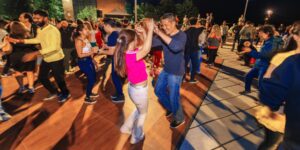 A crowd dancing outdoors at night
