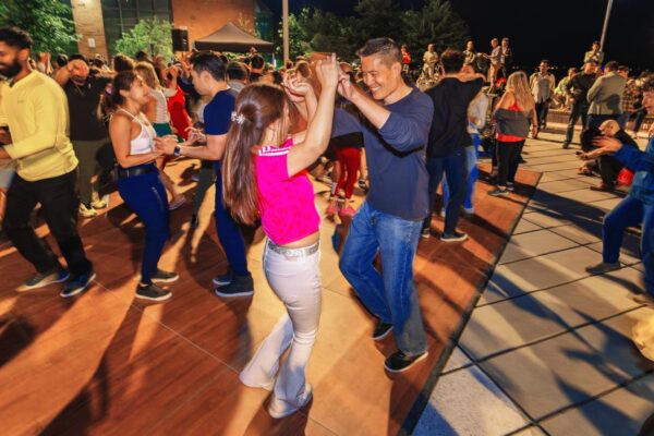 A crowd dancing outdoors at night