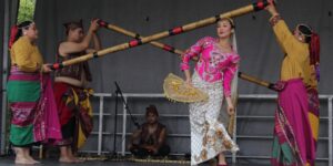 Four performers dancing on stage in colourful clothing