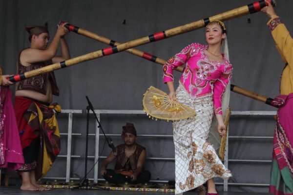 Four performers dancing on stage in colourful clothing
