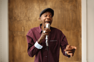 An artist singing into a microphone