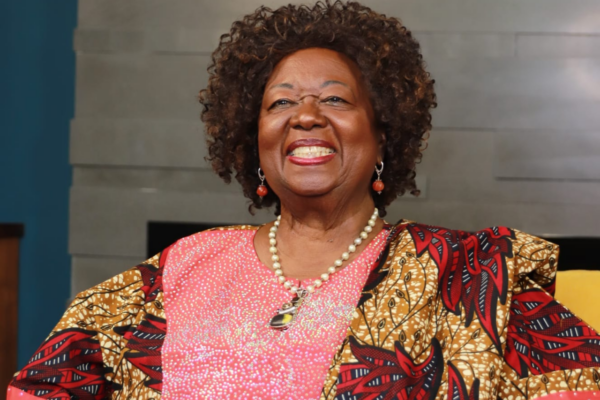 A woman smiling and wearing bright clothing