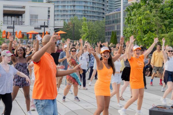 A woman teaching an outdoor dance class.