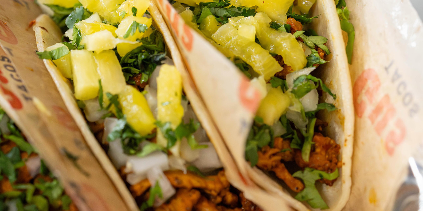 tasty looking tacos in paper wrapping
