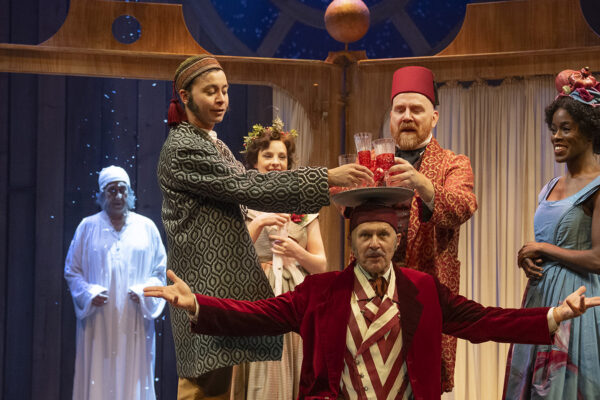 A stage of people in costumes performing a play