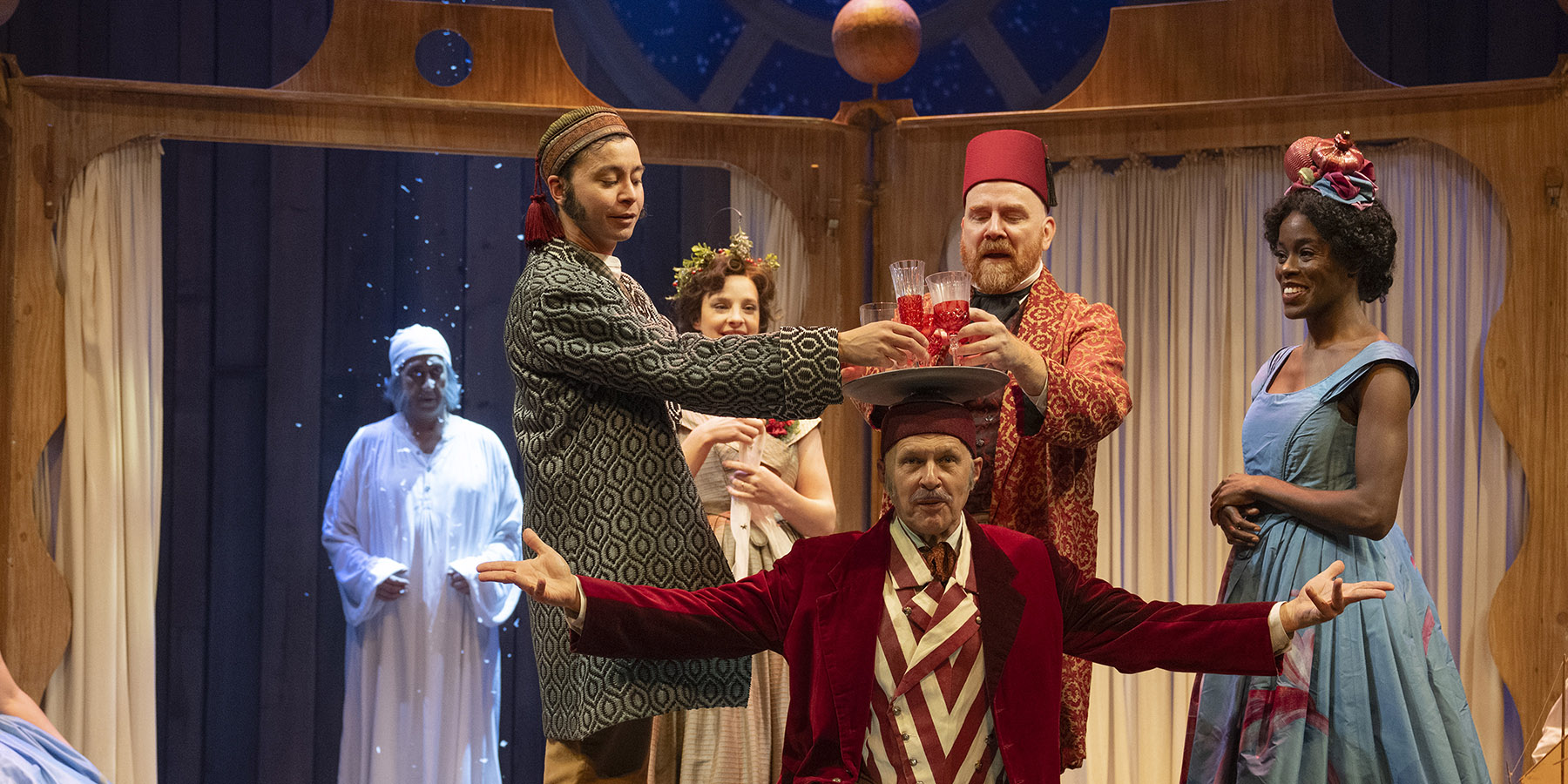 A stage of people in costumes performing a play
