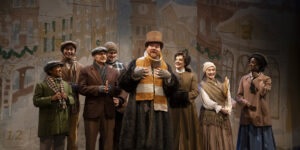 Actors on stage with vintage winter clothing