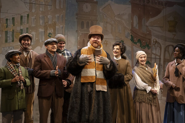 Actors on stage with vintage winter clothing