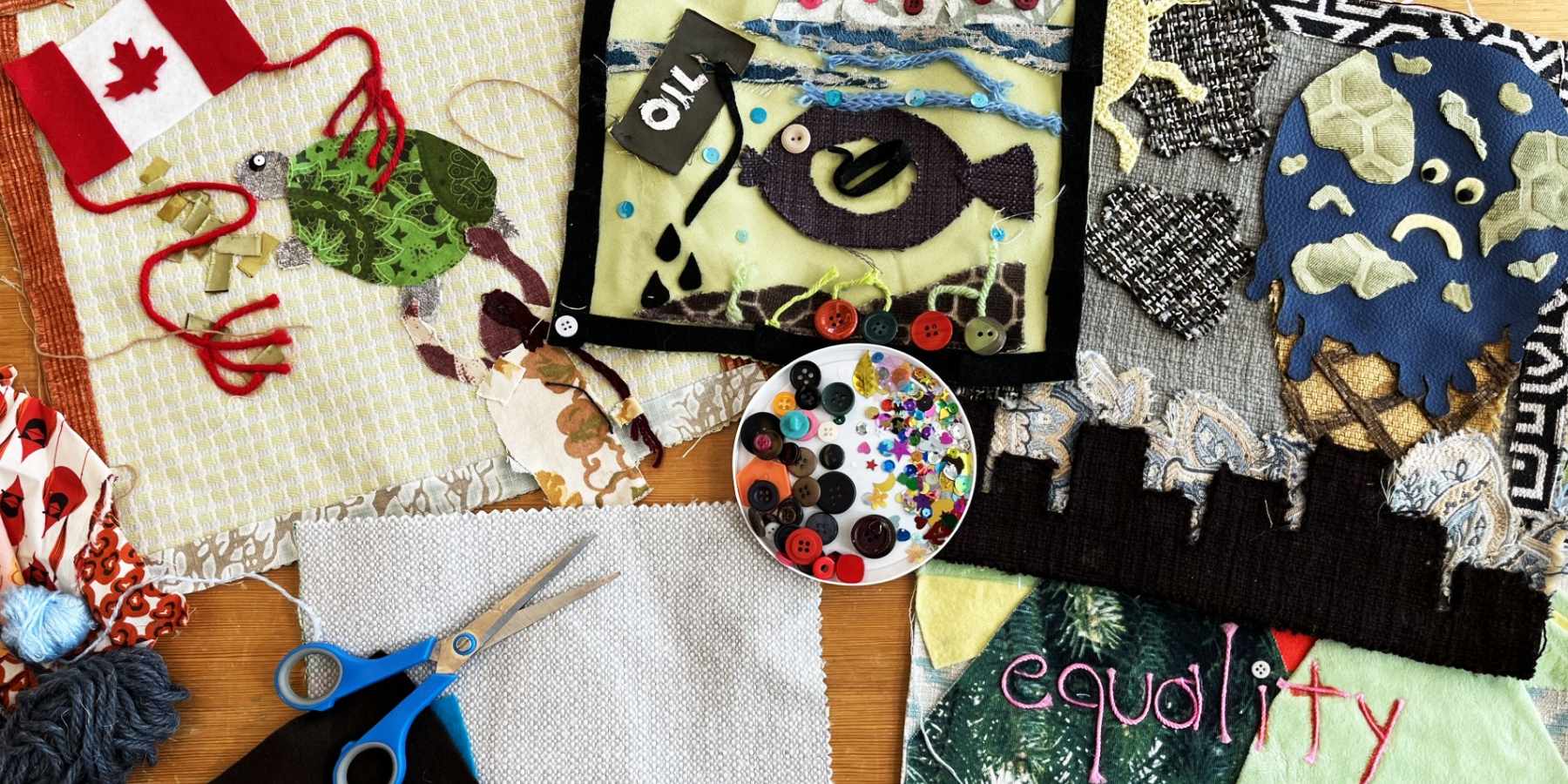 A spread of various textiles and crafts on a table.