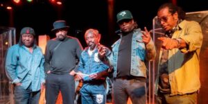A group of five musicians posing for the camera