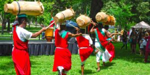 A line of drummers wearing bright red attire