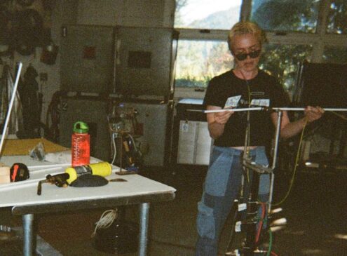 An artist blowing glass