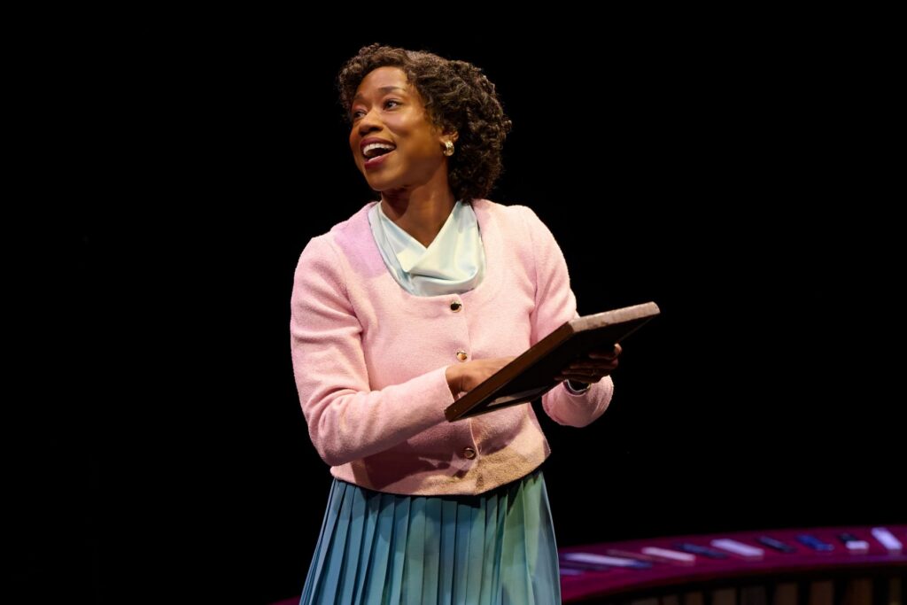 Woman holding a book doing a performance on stage