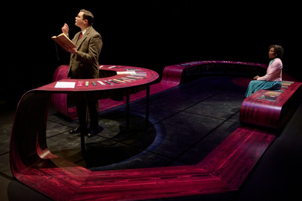 Two actors on a stage in performance.