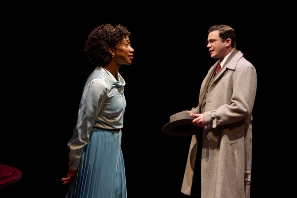 Two actors on a stage in performance.