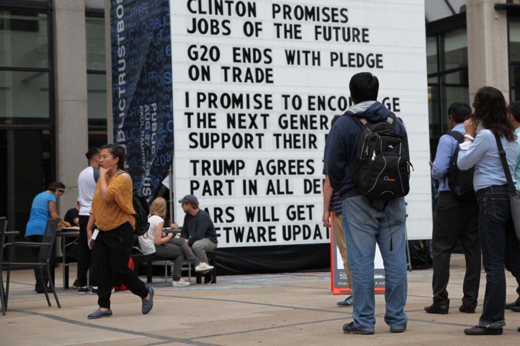 People standing outside looking at an outdoor art installation