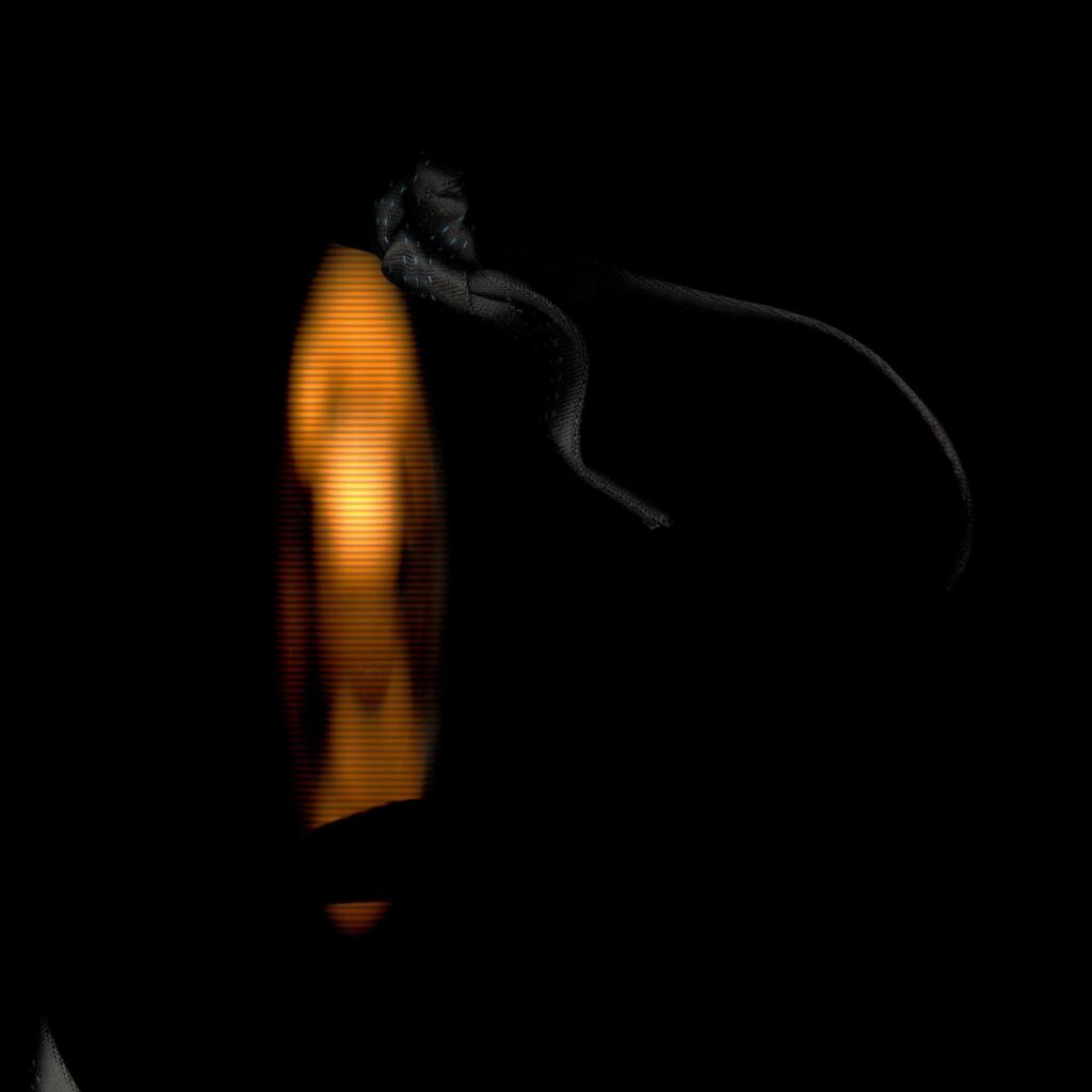 A close-up shot of a dark bakcground with a vivid orange visual
