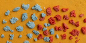 A close-up shot of ceramic pieces against a yellow background.